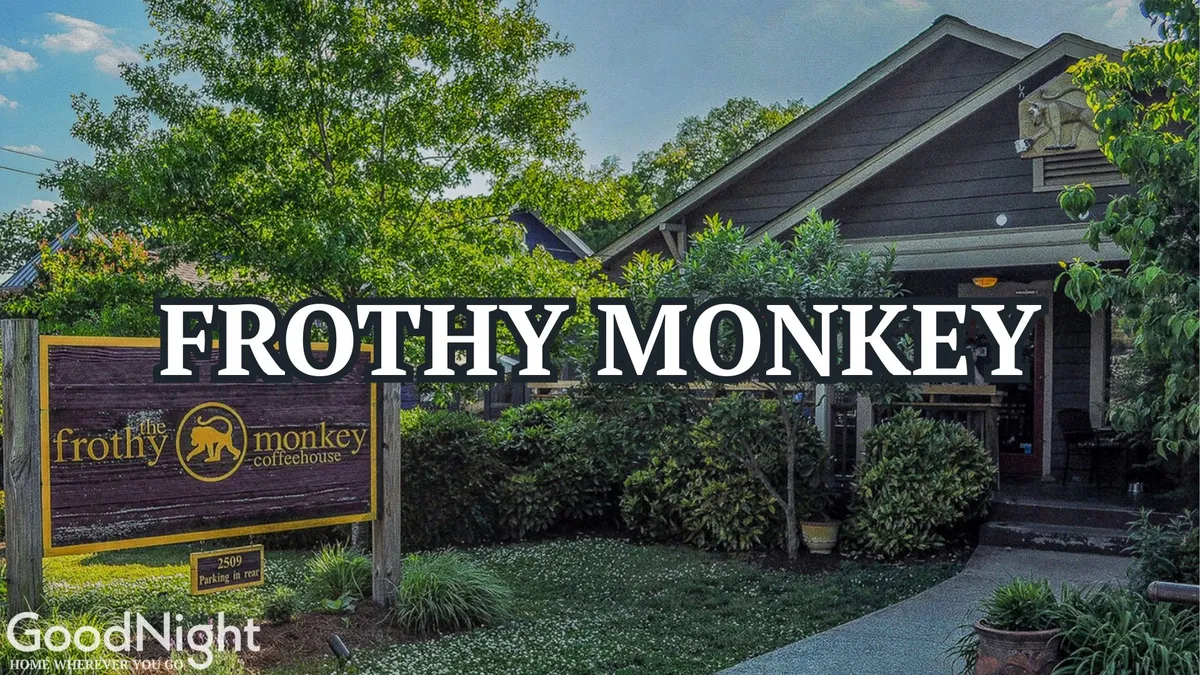 This image captures the exterior of Frothy Monkey, a beloved local coffeehouse, with its inviting sign, lush surrounding greenery, and a welcoming entrance. The scene suggests a friendly spot ideal for socializing, meeting friends, or enjoying a unique Nashville coffee experience.