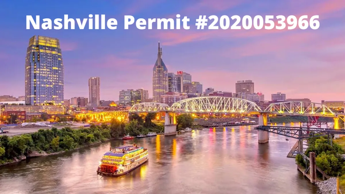 A sweeping view of Nashville’s skyline at night, with bridges illuminated and a classic riverboat cruising the river. City lights twinkle, suggesting a thriving nightlife and a city that comes alive after dark.